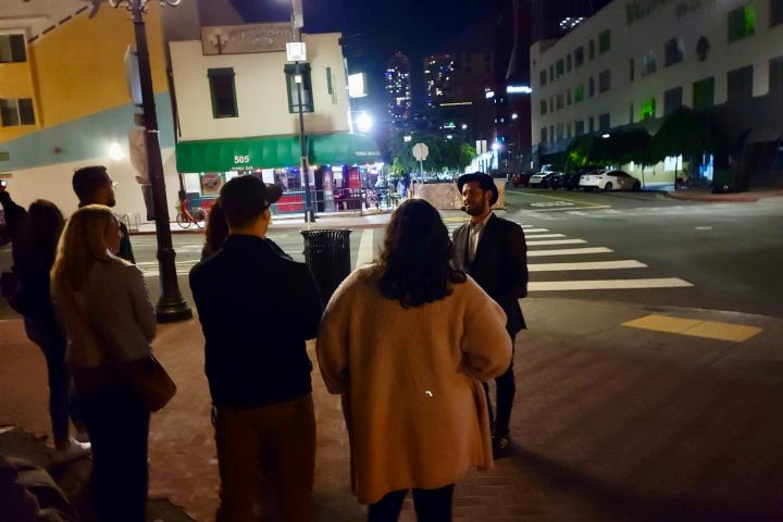a group of people standing on a sidewalk