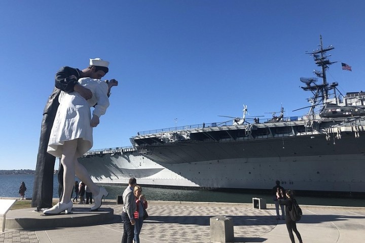 a group of people walking on a beach