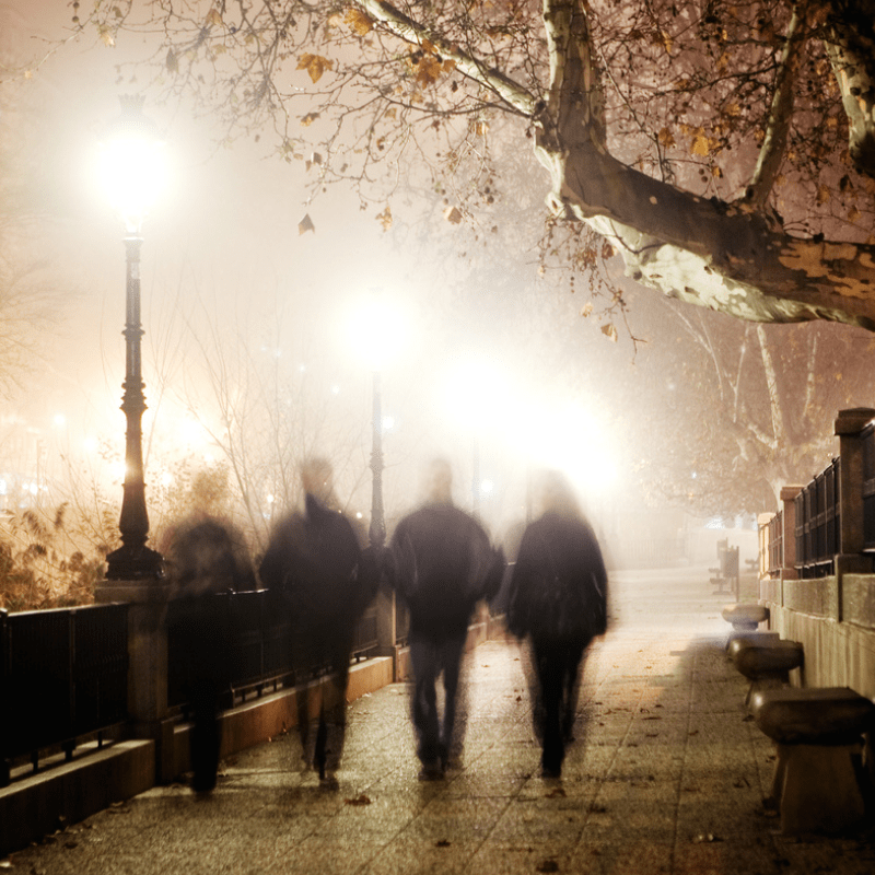 a group of people walking in the rain