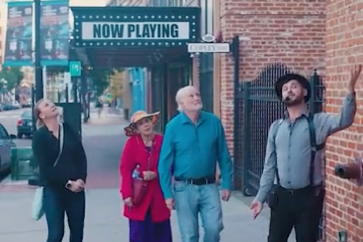 a group of people walking on a sidewalk