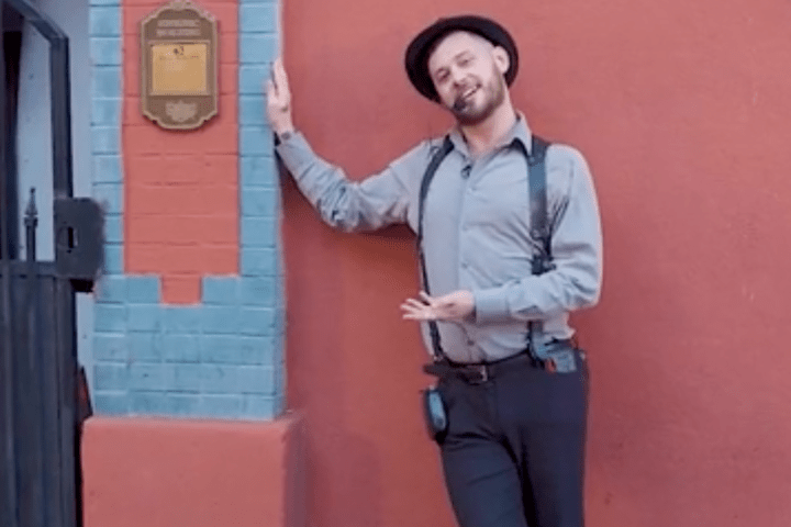 a person standing in front of a brick building