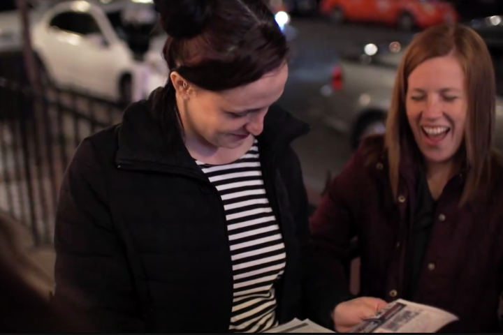 a group of people looking at a laptop