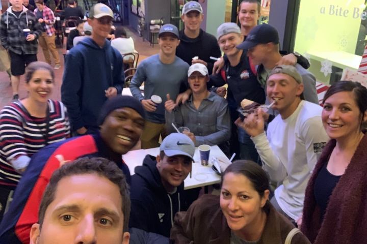 a group of people standing in front of a crowd posing for the camera